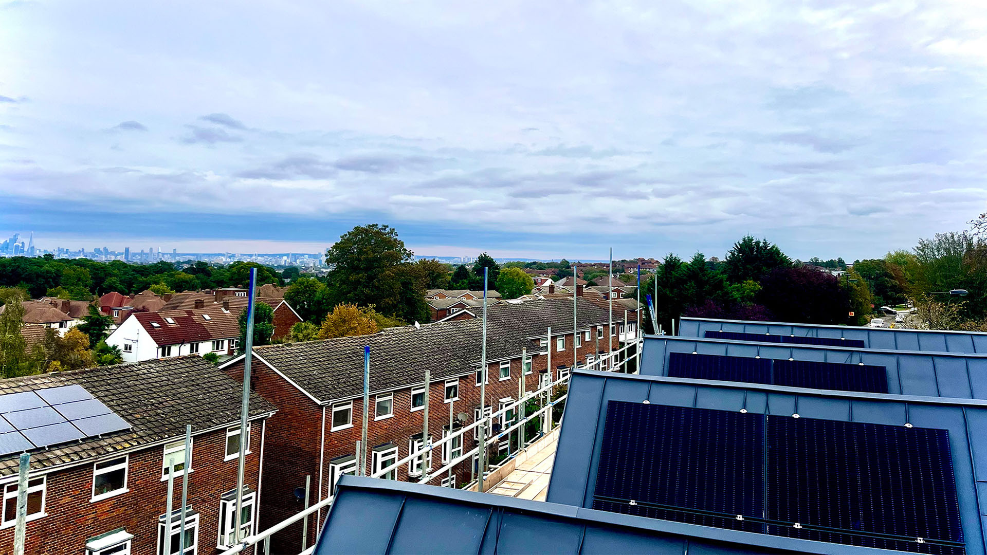 Solar panels on a commercial roof with surrounding town in the background